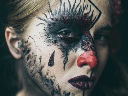 Halloween, the face of a girl is a doll, the floor of a face is dead. A woman with a horrible make-upの写真素材