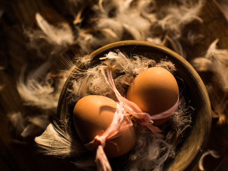 Easter eggs in the nest of feathersの写真素材