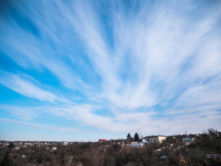 Clouds in the blue sky over a small village.の写真素材