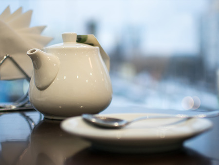 White cup on the table, breakfast in a cozy cafe.の写真素材
