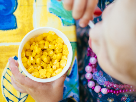 cup corn baby food in the parkの写真素材