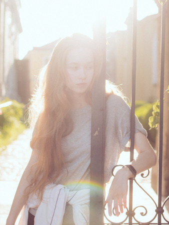 Young woman standing in the gardenの写真素材