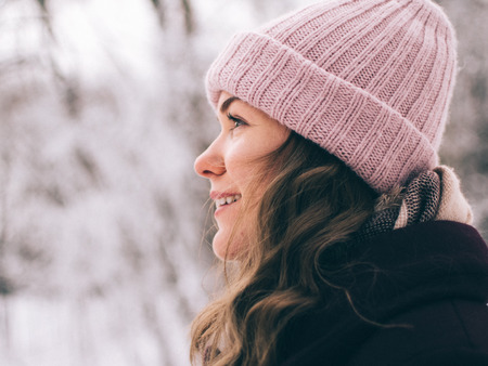 Close up portrait of young caucasian woman outdoors, winter portrait of smiling girlの写真素材
