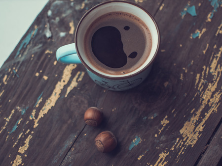 Coffee cup on the wooden background in rustic styleの写真素材