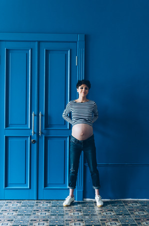 A young girl in anticipation of a child. Stylish studio photo.の写真素材