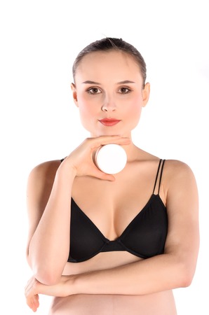 Pregnant woman with cosmetics cream in her handの写真素材