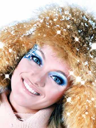 Beauty Winter Girl Blowing Snow in frosty winter.の写真素材