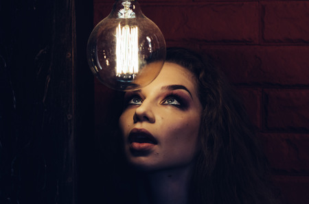 Woman surrounded by many lamps