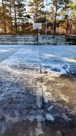 Abandoned basketball court in the middle of the forest. Wintertime photoの写真素材