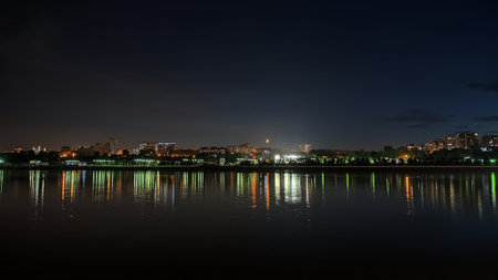 Bright Moon above the night city and river. Urban Landscape
