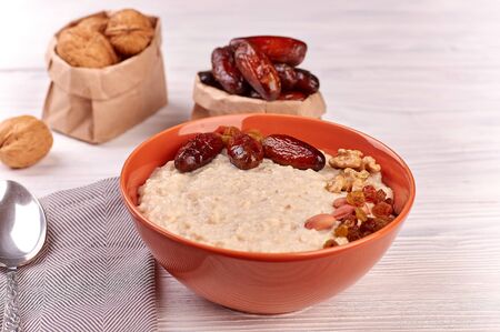 porridge with fruit on wooden background