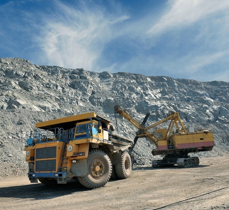 Loading of iron ore on very big dump-body truck