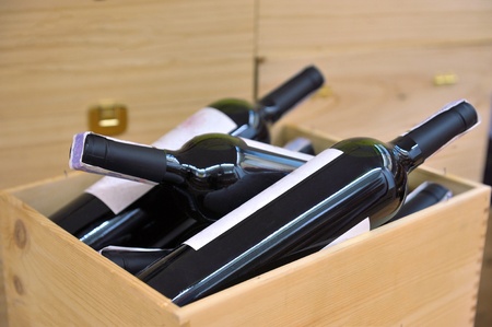 Red and white wine in bottles in wine shopの写真素材