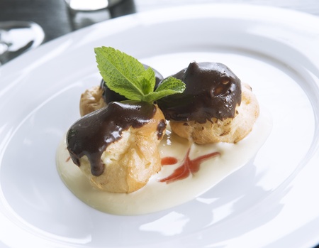 chocolate eclairs on white plate