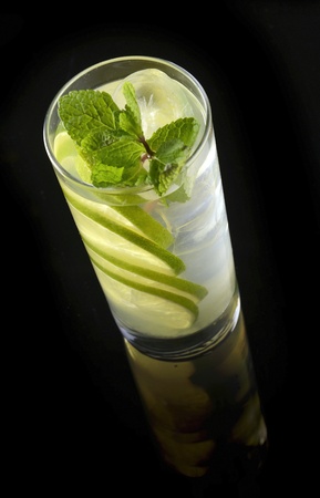 lemonade with lime and ice on a black background