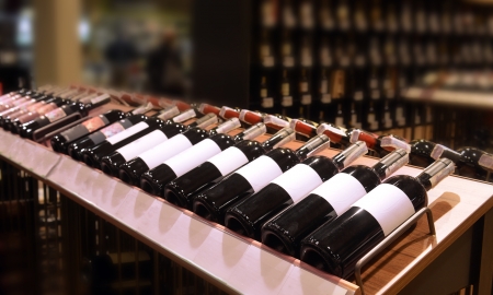 Red and white wine in bottles in wine shop