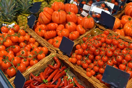 Tomatoes on display in a supermarketの写真素材