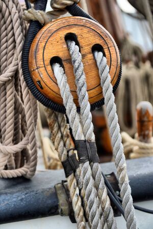 Ancient wooden sailboat pulleys and ropes detailの写真素材