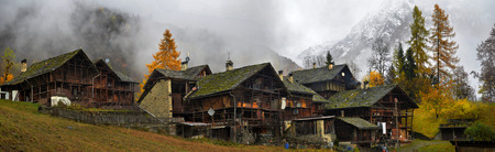autumn landscape in the Alps with mist and clouds