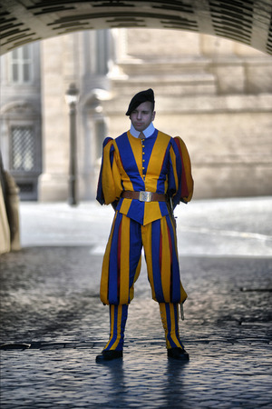 VATICAN, ITALY - SEPTEMBRE 26, 2014: Swiss guard with nice uniform outside in Vatican streets, nice...