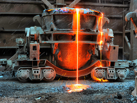 Old slag disposal pots mounted on railway platforms in blast furnace workshop on Mining and metallurgical plantの写真素材