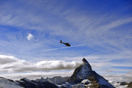 escue helicopter over the Matterhorn mountain in Switzerlandのeditorial素材