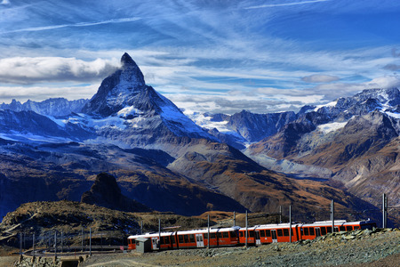 Zermatt Switzerland. Famous electric red tourist train coming down  in Zermatt Valais region Switzerland Europe.の写真素材