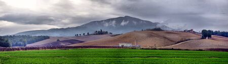 typical Tuscany countryside landscape; sunset over rolling hills and Tuscany farmlandの写真素材