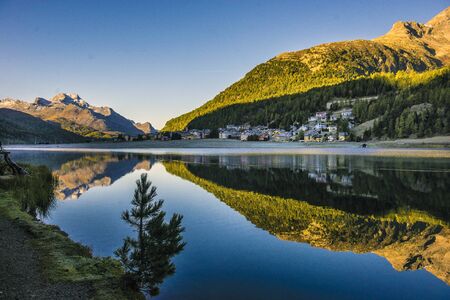 Mountain lake panorama with mountains reflection. Idyllic look. Autumn forest. Silvaplana Lake, Switzerlandの写真素材