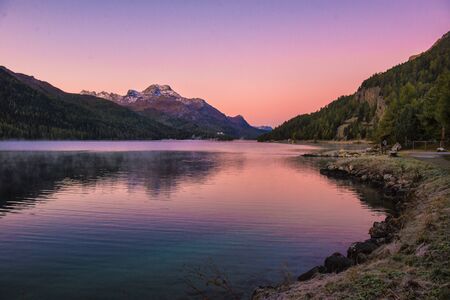 Mountain lake panorama with mountains reflection. Idyllic look. Autumn forest. Silvaplana Lake,...