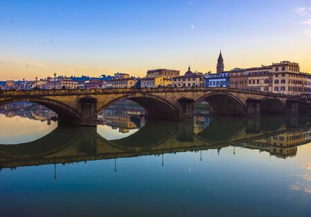 Florence, Ponte alla Carraia medieval Bridge landmark on Arno river at sunset. Tuscany, Italy.の写真素材