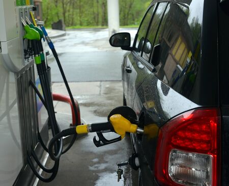 refilling up gas tank of the car with green eco fuel on a filling station