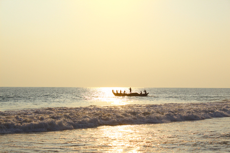 Fishermen in a boat floating in the oceanの写真素材