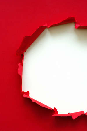 Wrinkled ripped torn red paper with hole in center background texture poster backdrop empty spaceの写真素材
