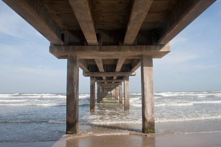 A pier juts into the ocean at the Gulf of Mexico in Texas.の写真素材