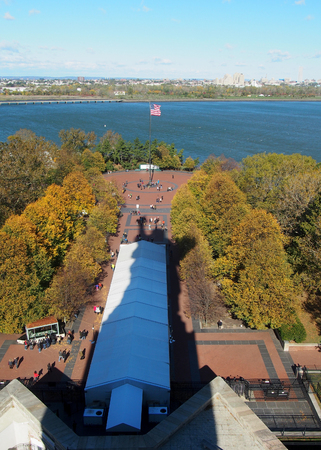 The shadow of the statue of liberty falls over the island.の写真素材