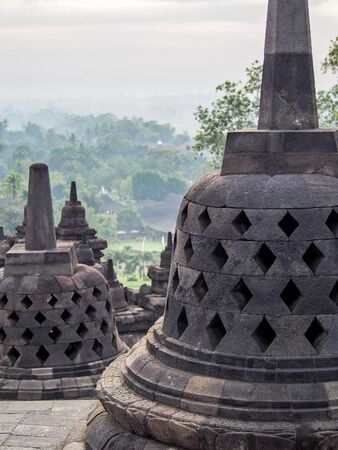 Bell-shaped stupas decorate the Borobudur temple near Yogyakarta Indonesia.
