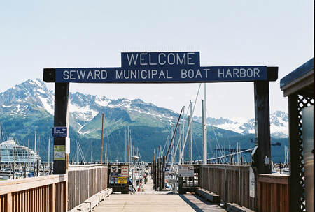 A sign marks the entrance to the Seward Municipal Boat Harbor in Seward, Alaska.のeditorial素材