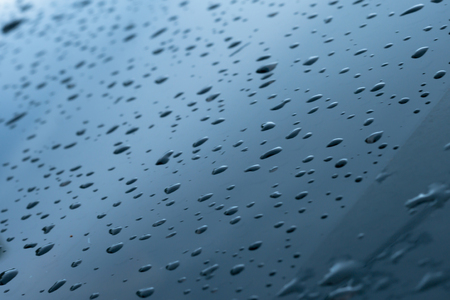 driping water on the window car, raining drop on glass. blur vissionの写真素材