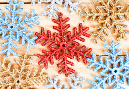 Full frame snowflakes background on the wooden boardの写真素材