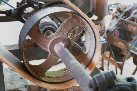 Close up old pulley machine with belt and rotary gear factory.の写真素材