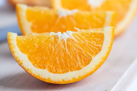 Close-up sliced orange on the cutting board. Many types of oranges can be eaten. The fruit is sour or sweet. Often have extra calcium, potassium, vitamin A and vitamin C.の写真素材
