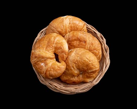 Croissant in the Wicker basket on the black background   .の写真素材