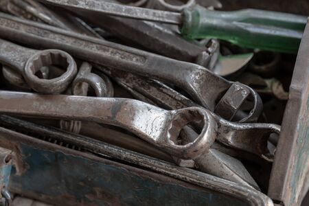 Close up old tools consisting of screwdrivers and spanners put in a metal box.の写真素材
