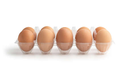 Chicken eggs in the plastic box isolated on the white background with clipping pathsの写真素材