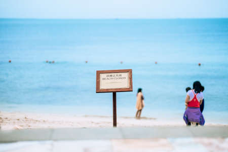 Closed public beach with a sign that swimming is prohibited. High quality photo
