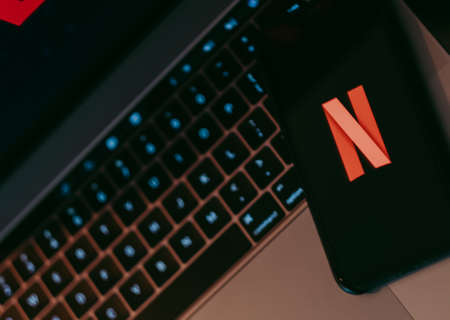 iPhone with Netflix logo screen.