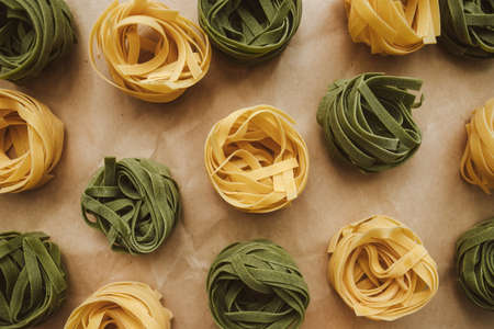 Italian wheat pasta tagliatelle, with spinach, on a craft paper. Top viewの写真素材