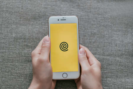 Yandex food app, hands holding iPhone with screen of yandex food app.のeditorial素材