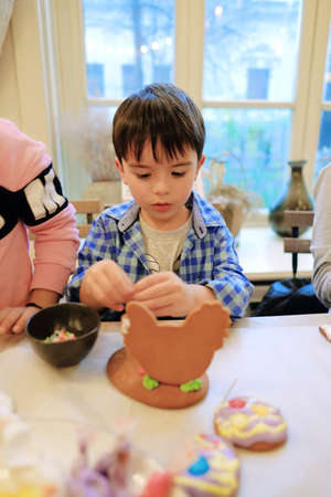 Children's hands make gingerbread. children cutting cookies. Kids baking cookies. Concept. Master class for children on baking gingerbread. High quality photoのeditorial素材